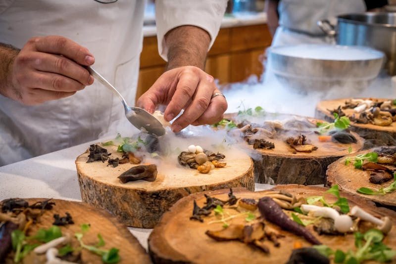 a chef preparing some dishes and appetizers